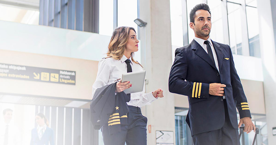 A male and a female pilot walk into the airport.