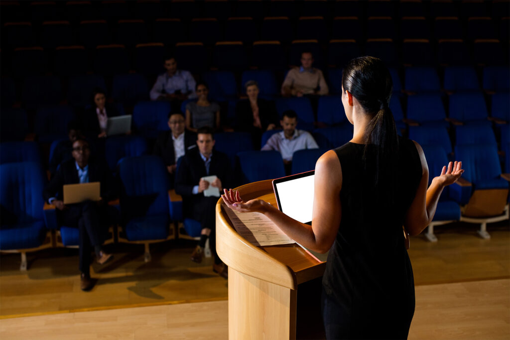 A woman giving a presentation to an audience